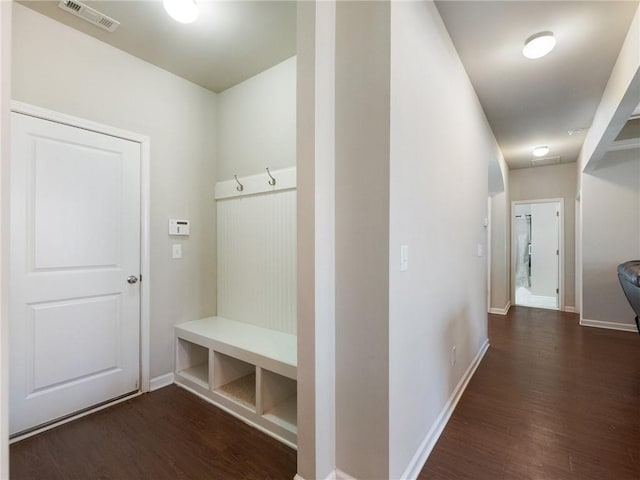 mudroom with wood finished floors, visible vents, and baseboards