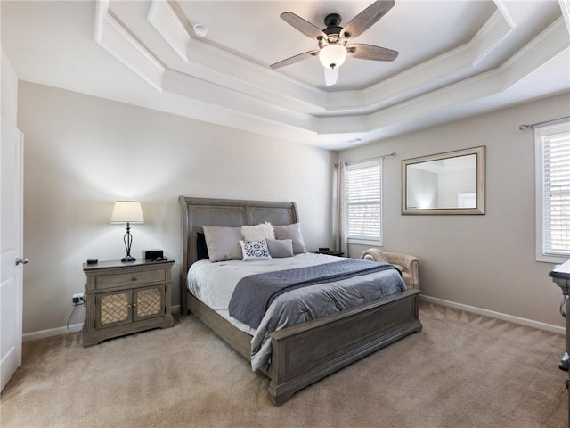 bedroom with light carpet, a raised ceiling, baseboards, and ornamental molding