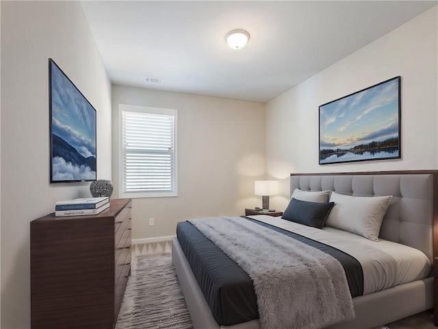 bedroom with visible vents and baseboards