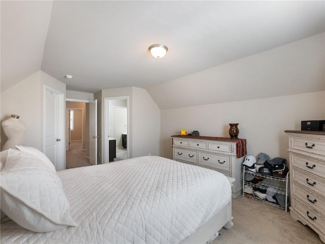 bedroom featuring vaulted ceiling and light carpet