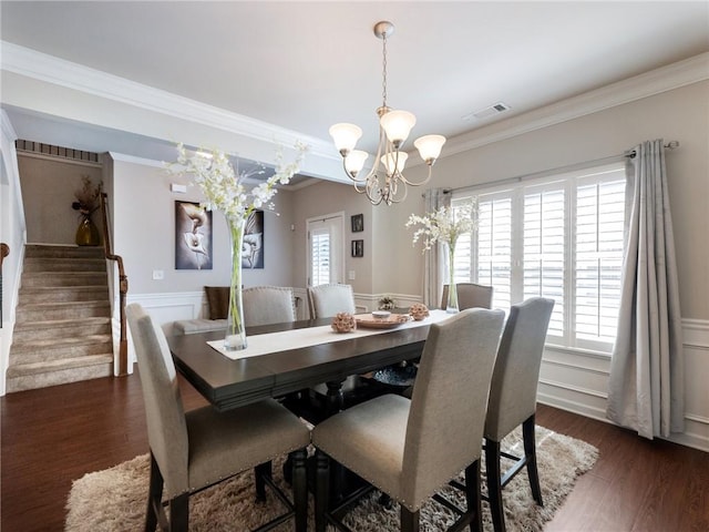 dining space with a wealth of natural light, wainscoting, and stairs