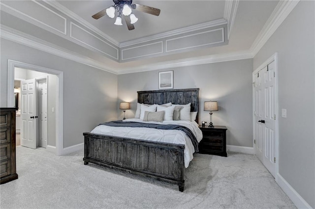 bedroom featuring light carpet, a ceiling fan, crown molding, and baseboards