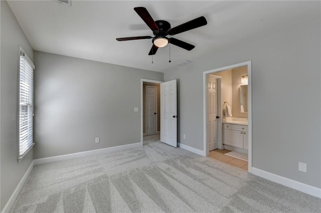 unfurnished bedroom with multiple windows, visible vents, baseboards, and light carpet