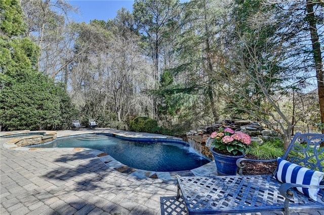 view of pool with a pool with connected hot tub and a patio