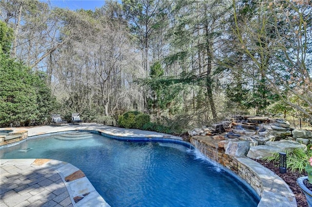 view of swimming pool with a patio area and a pool with connected hot tub