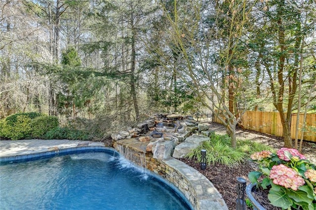 view of pool with a fenced in pool and fence