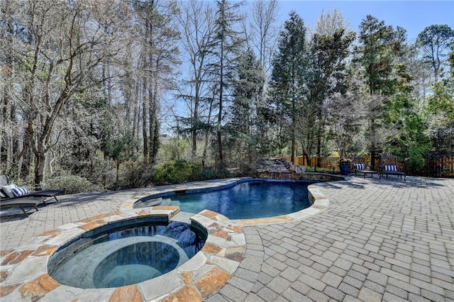 view of swimming pool featuring a patio area and a pool with connected hot tub