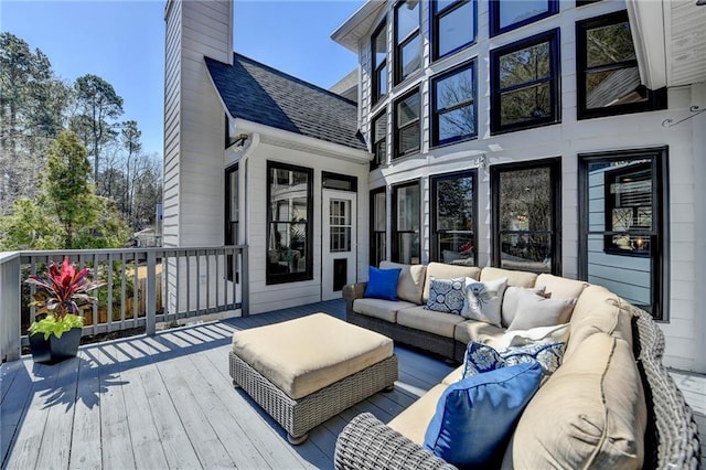 wooden terrace featuring an outdoor living space