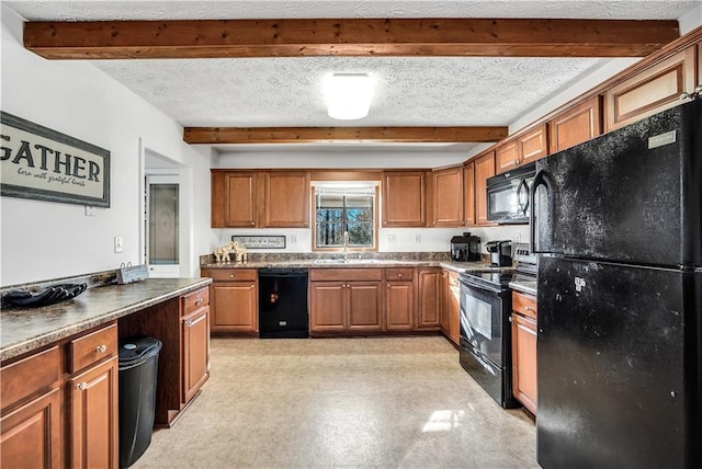 kitchen with sink, a textured ceiling, and black appliances