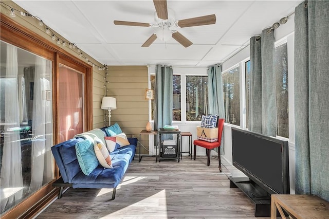 sunroom featuring ceiling fan