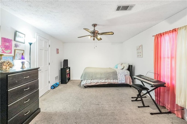 bedroom with carpet, a textured ceiling, and ceiling fan