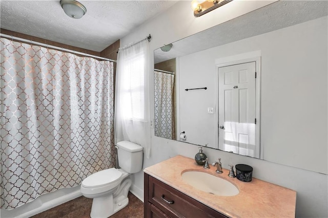 bathroom featuring vanity, toilet, and a textured ceiling