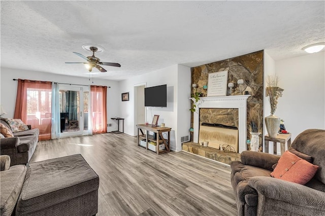 living room featuring ceiling fan and dark hardwood / wood-style floors