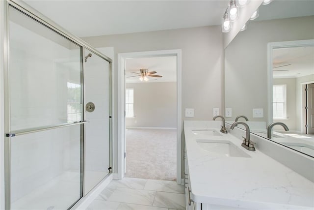 bathroom featuring walk in shower, vanity, and ceiling fan