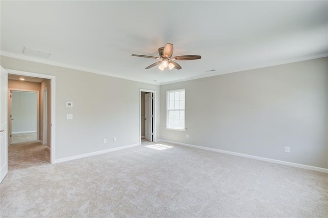 carpeted empty room featuring ceiling fan and ornamental molding