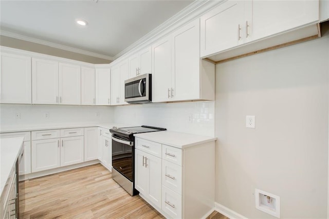 kitchen with backsplash, white cabinetry, stainless steel appliances, and light hardwood / wood-style flooring