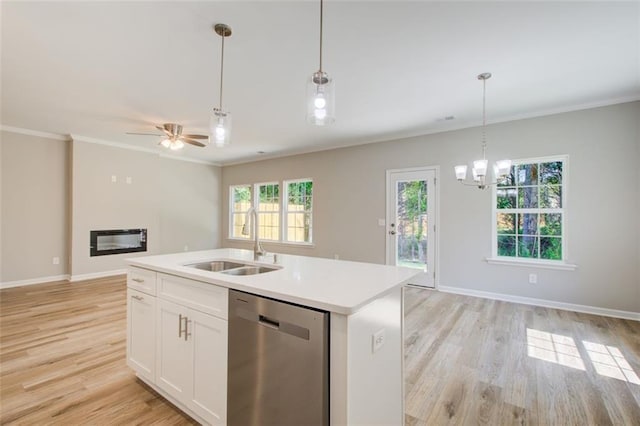 kitchen with stainless steel dishwasher, sink, decorative light fixtures, a center island with sink, and white cabinetry