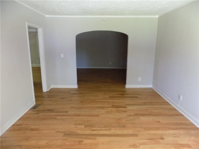 unfurnished room with light hardwood / wood-style flooring and ornamental molding