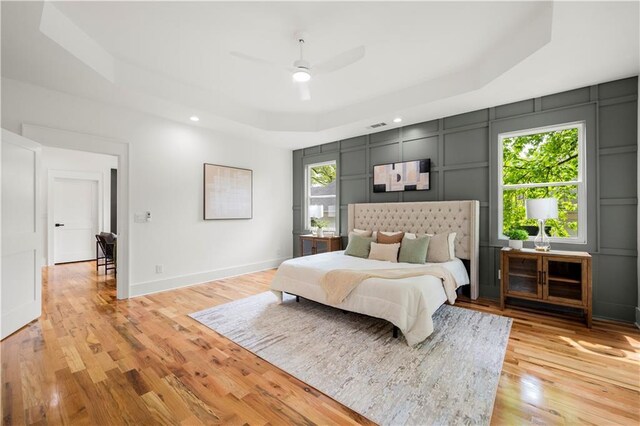 224 Cambridge Ave, Decatur, GA 30030 - bedroom featuring a raised ceiling, light wood finished floors, recessed lighting, a decorative wall, and baseboards
