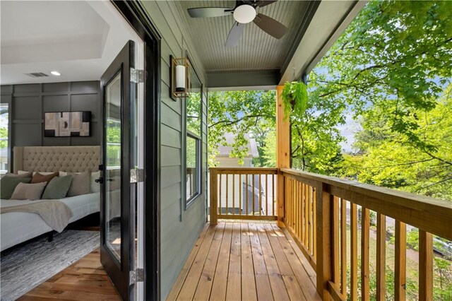 224 Cambridge Ave, Decatur, GA 30030 - bedroom with access to outside, a tray ceiling, light wood-style floors, a decorative wall, and baseboards