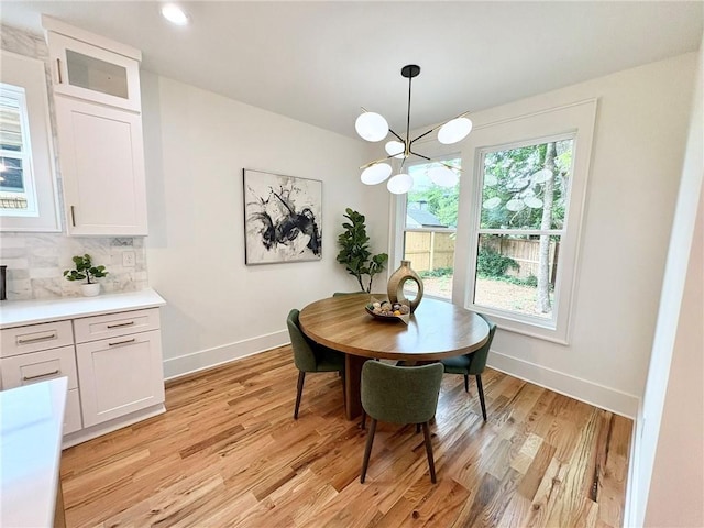 224 Cambridge Ave, Decatur, GA 30030 - dining area featuring baseboards, light wood-style floors, and a chandelier