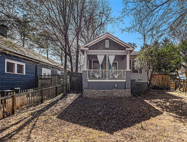 view of front of house with fence private yard and covered porch