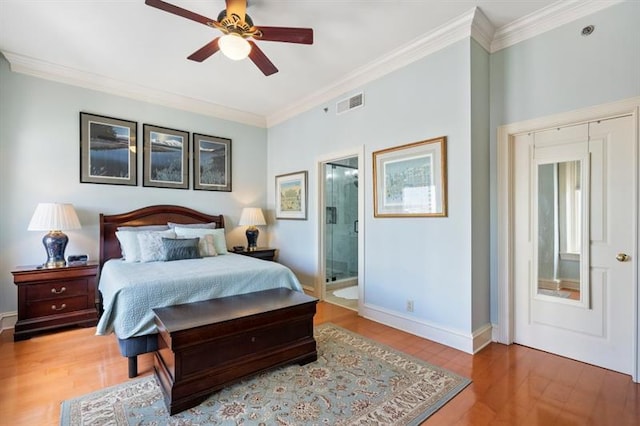 bedroom with baseboards, visible vents, ensuite bath, ornamental molding, and wood finished floors