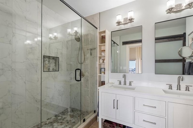 full bathroom featuring a sink, a shower stall, and double vanity