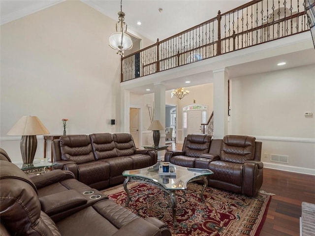 living room featuring a notable chandelier, high vaulted ceiling, crown molding, and dark hardwood / wood-style flooring