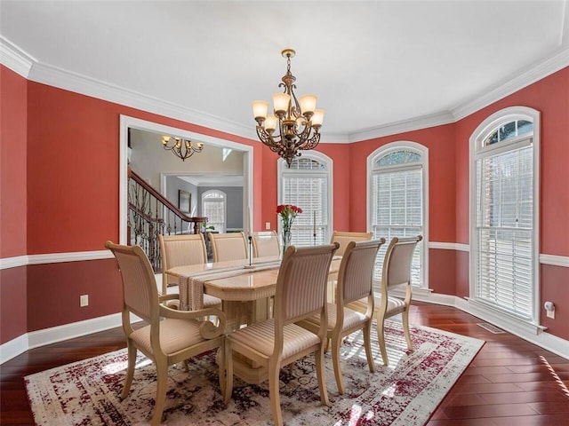 dining room featuring ornamental molding, plenty of natural light, and a chandelier