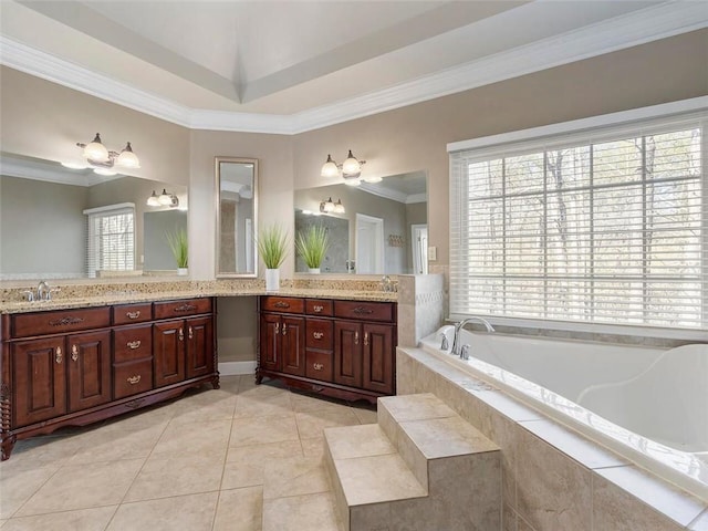 bathroom featuring crown molding, a relaxing tiled tub, tile patterned flooring, and vanity