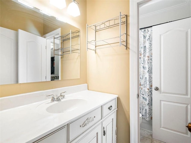 bathroom with a shower with shower curtain, vanity, toilet, and tile patterned floors