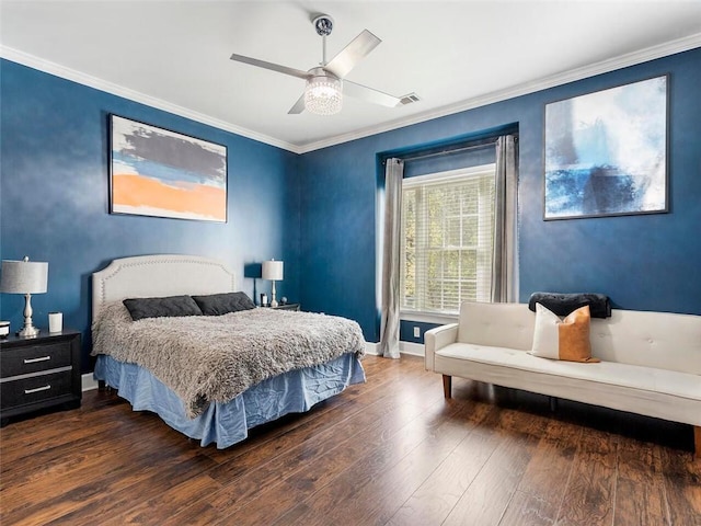 bedroom with dark wood-type flooring, ornamental molding, and ceiling fan