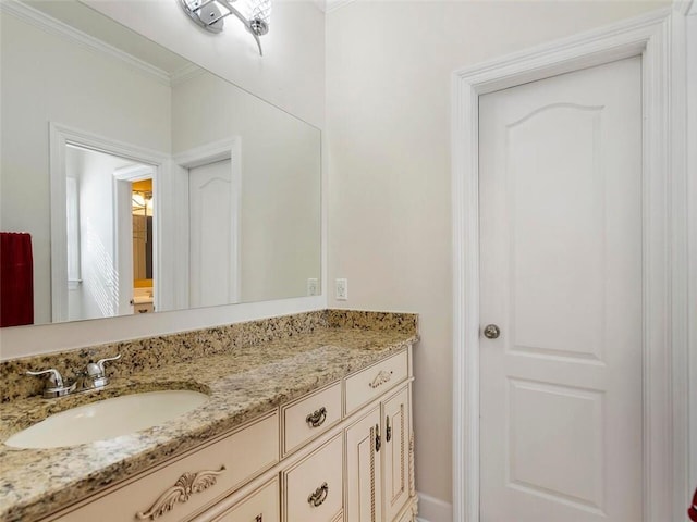 bathroom with ornamental molding and vanity