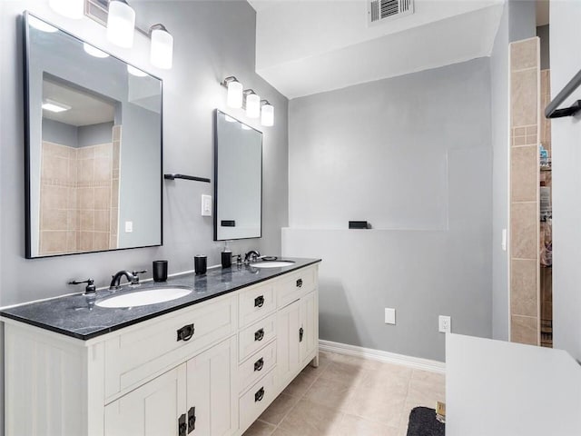 bathroom with tile patterned flooring and vanity