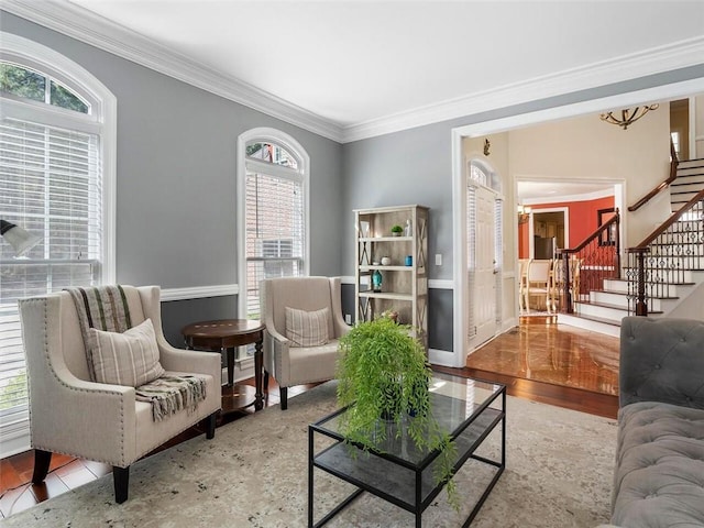 living area with ornamental molding and light hardwood / wood-style floors