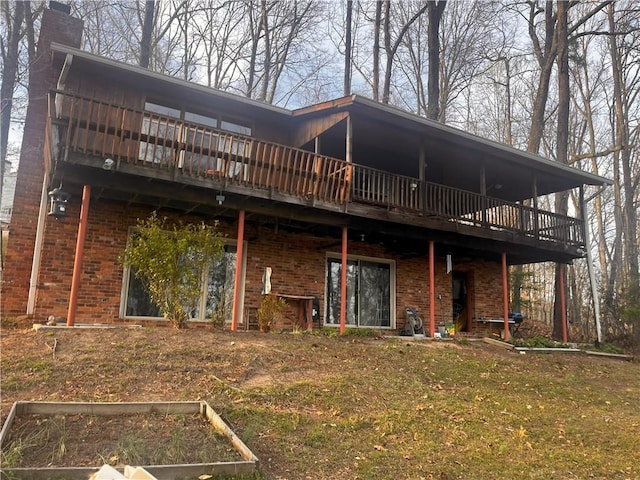 9165 Duran Cir, Gainesville, GA 30506 - back of property featuring brick siding, a vegetable garden, a chimney, and a lawn