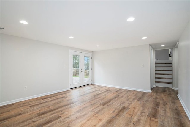 unfurnished room featuring light hardwood / wood-style floors and french doors