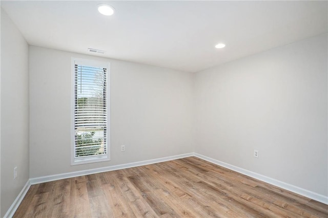 unfurnished room with light hardwood / wood-style flooring