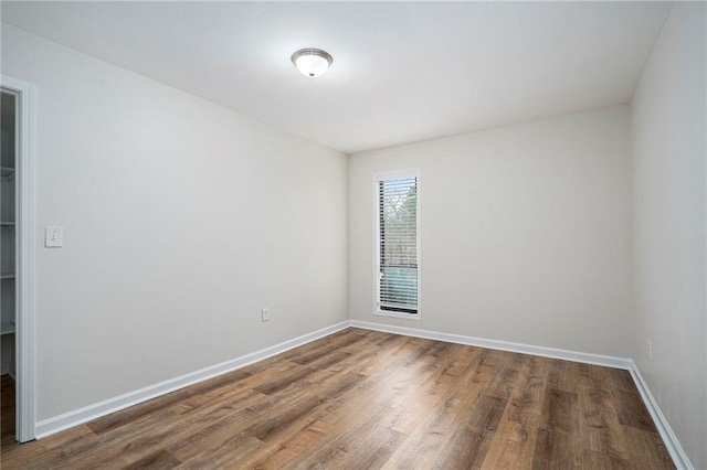 spare room featuring wood-type flooring