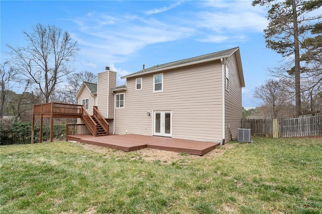 rear view of property with a yard, cooling unit, a deck, and french doors