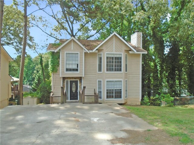 view of front of house with an outbuilding and a front yard