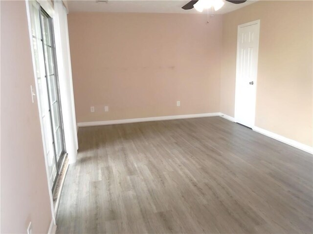 spare room with ceiling fan and wood-type flooring