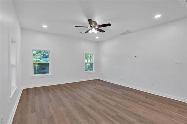 unfurnished room with hardwood / wood-style flooring and ceiling fan