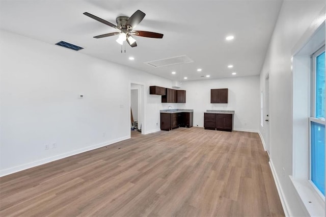 unfurnished living room with light hardwood / wood-style flooring and ceiling fan