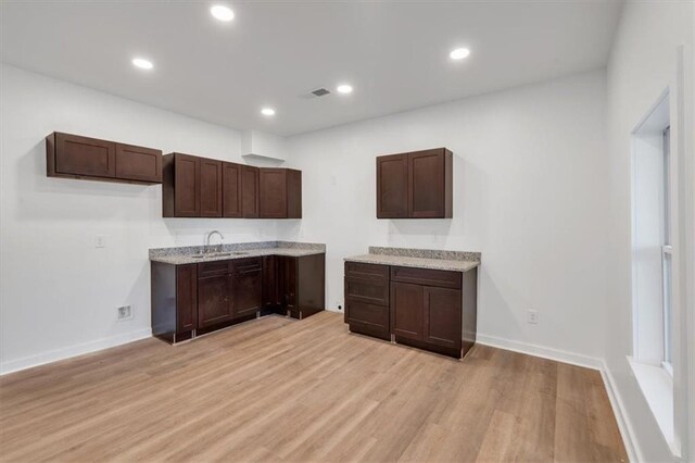 5361 N Main St, Acworth, GA 30101 - kitchen featuring dark brown cabinetry, light wood-type flooring, and baseboards