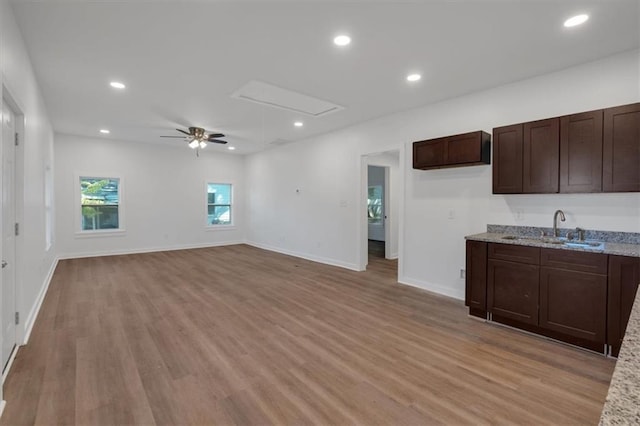 5361 N Main St, Acworth, GA 30101 - kitchen with a sink, dark brown cabinets, light wood-type flooring, and a ceiling fan