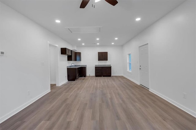 unfurnished living room featuring light hardwood / wood-style floors and ceiling fan