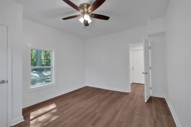 unfurnished room featuring ceiling fan and dark hardwood / wood-style flooring