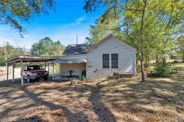 rear view of property featuring a carport